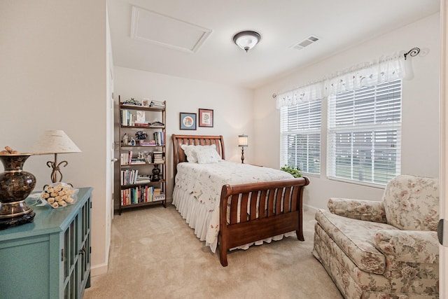 bedroom featuring attic access, visible vents, and light carpet