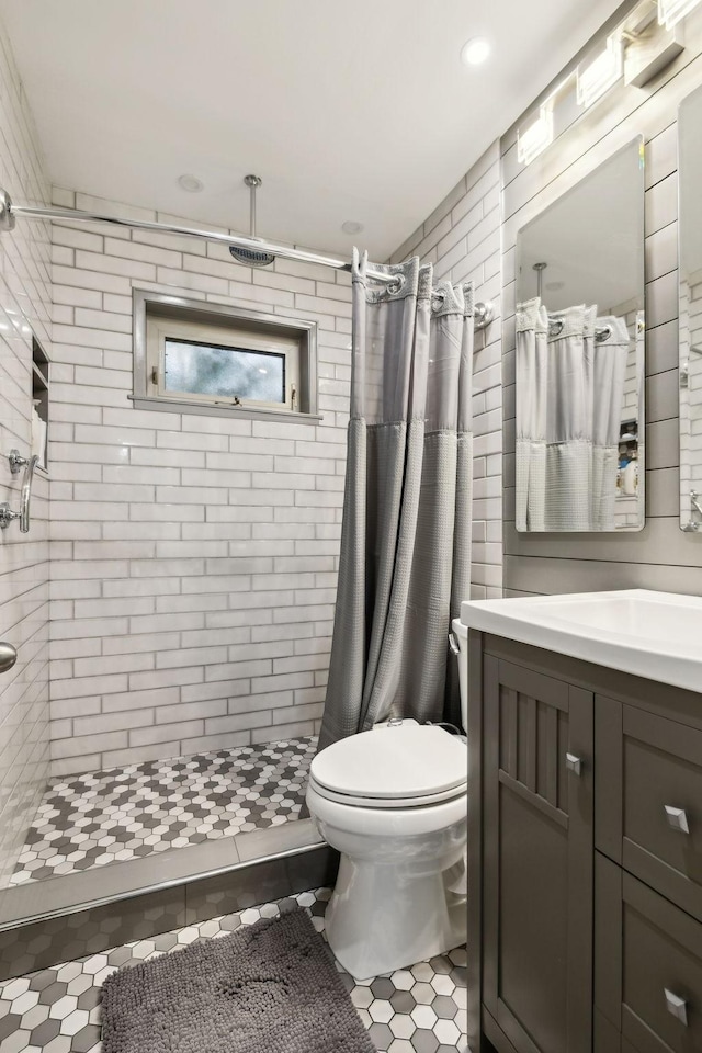 bathroom featuring a stall shower, vanity, toilet, tile patterned flooring, and recessed lighting