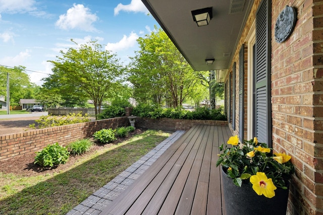 wooden terrace featuring fence