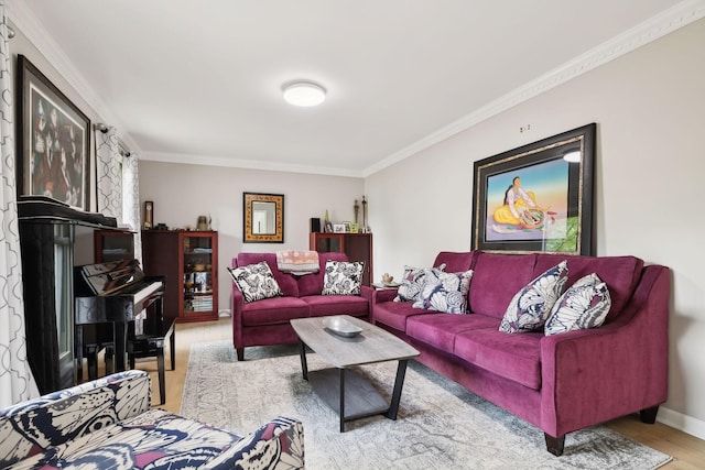 living room featuring baseboards, crown molding, and wood finished floors