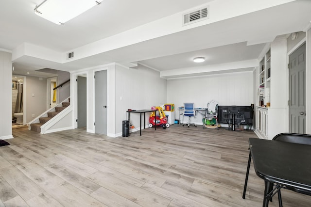 playroom with baseboards, wood finished floors, and visible vents