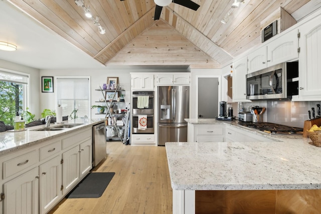 kitchen featuring stainless steel appliances, wooden ceiling, a sink, and a peninsula