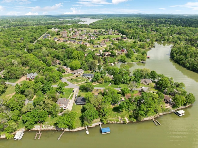 aerial view featuring a residential view, a wooded view, and a water view
