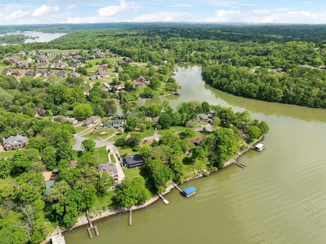 aerial view with a forest view, a water view, and a residential view