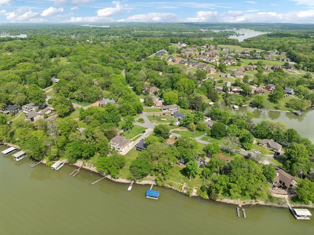 birds eye view of property with a residential view, a view of trees, and a water view
