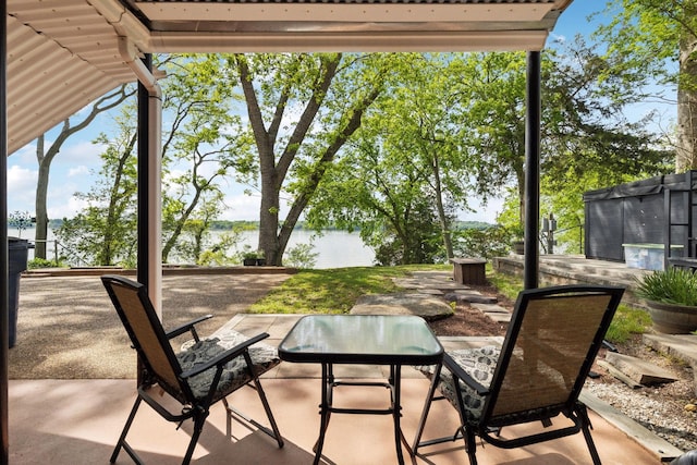 view of patio with a water view