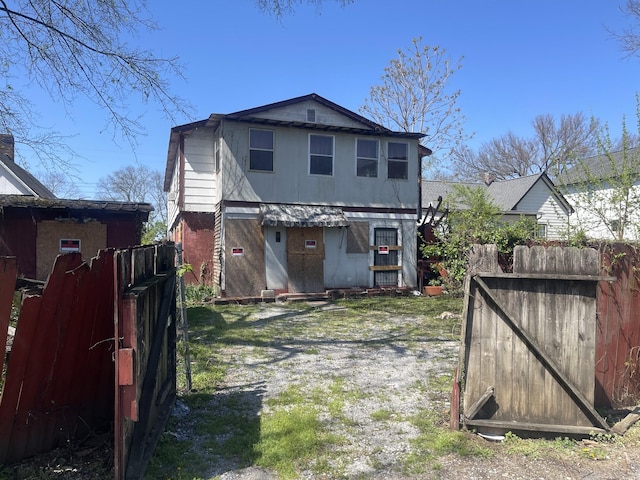 back of property featuring fence
