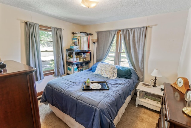 carpeted bedroom with a textured ceiling