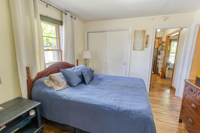 bedroom with light wood-style floors and a closet