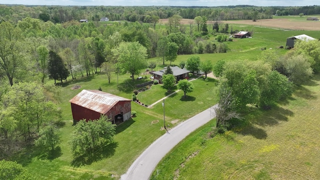 drone / aerial view featuring a rural view and a view of trees