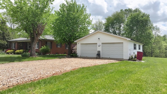 view of front facade featuring an outbuilding, a front yard, and a detached garage