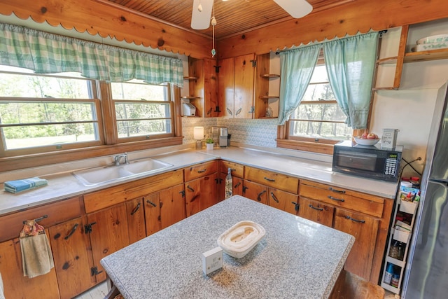 kitchen with open shelves, a sink, black microwave, wood ceiling, and light countertops
