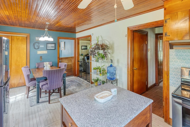 dining area featuring a chandelier, hardwood / wood-style floors, and ornamental molding