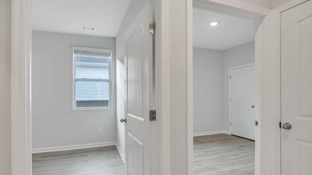 corridor featuring recessed lighting, wood finished floors, visible vents, and baseboards
