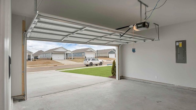 garage featuring a residential view, a garage door opener, and electric panel