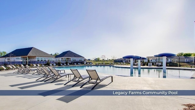 pool featuring a patio and fence