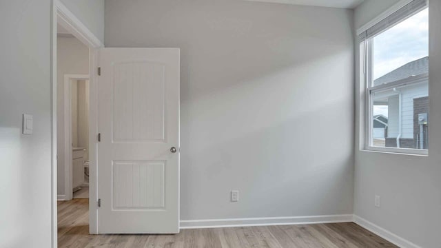 empty room featuring light wood-style flooring and baseboards