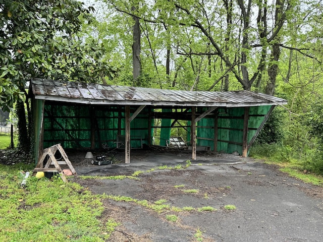 view of car parking with a detached carport and a pole building
