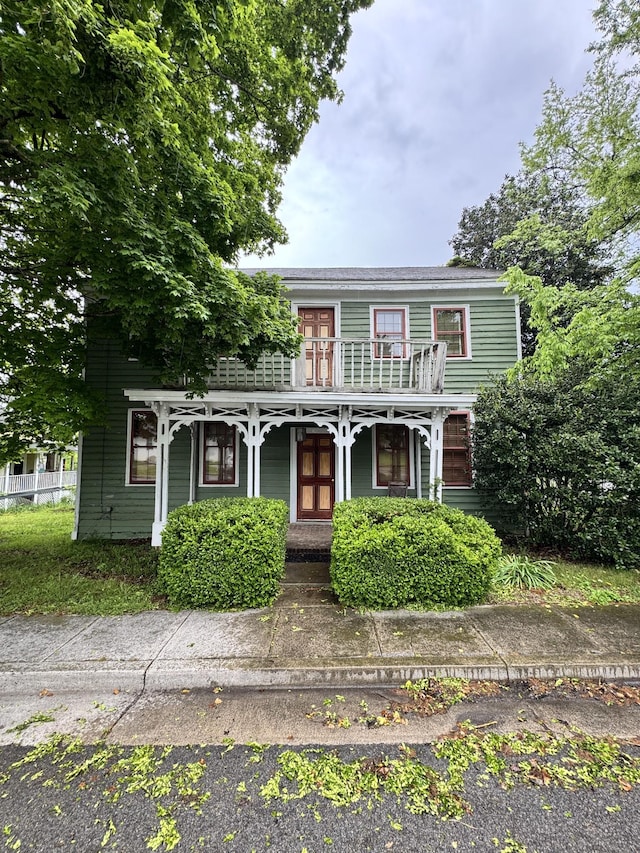 italianate home with covered porch and a balcony