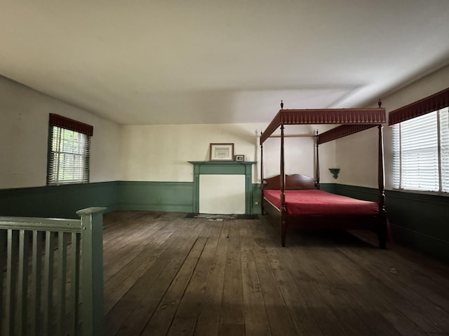 bedroom featuring hardwood / wood-style floors and wainscoting