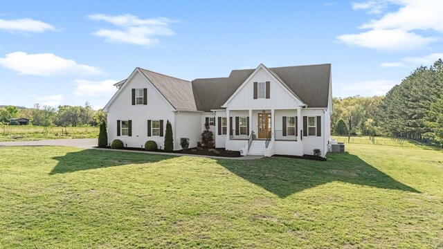 2040 Cairo Bend Rd, Lebanon, TN 37087 - view of front of home with central AC, board and batten siding, a front yard, and a sunroom