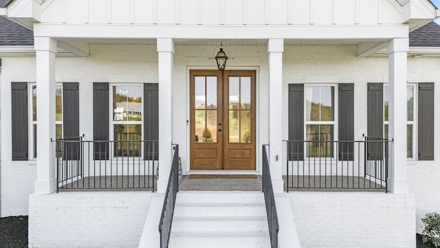 2040 Cairo Bend Rd, Lebanon, TN 37087 - entrance to property with a shingled roof, covered porch, board and batten siding, brick siding, and french doors