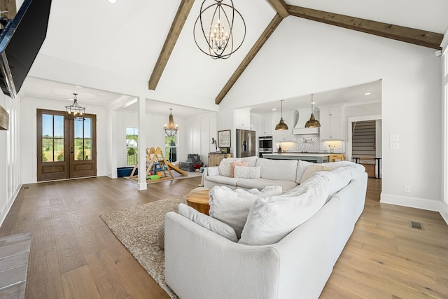 2040 Cairo Bend Rd, Lebanon, TN 37087 - living area with an inviting chandelier, beamed ceiling, light wood-style floors, visible vents, and high vaulted ceiling