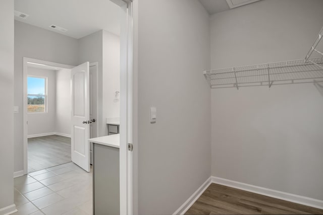 walk in closet with light wood-style flooring and visible vents