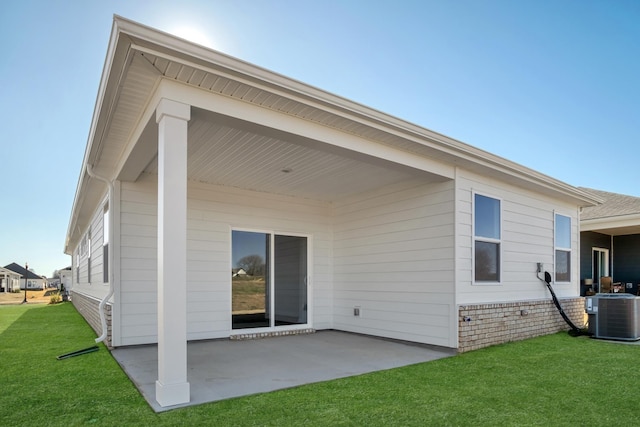 back of house with a lawn, a patio area, and cooling unit