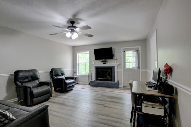 3473 Hunters Rdg, Woodlawn, TN 37191 - living room with light wood-style floors, ceiling fan, a wealth of natural light, and a fireplace