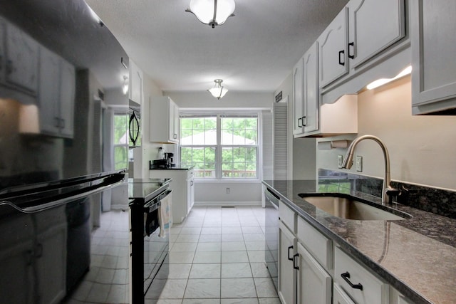 3473 Hunters Rdg, Woodlawn, TN 37191 - kitchen with a sink, dark stone counters, black appliances, and white cabinetry