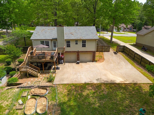 3473 Hunters Rdg, Woodlawn, TN 37191 - back of house featuring a chimney, a wooden deck, a garage, stairway, and concrete driveway