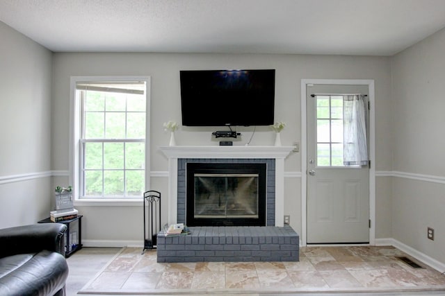 3473 Hunters Rdg, Woodlawn, TN 37191 - living area with baseboards, plenty of natural light, a fireplace, and visible vents