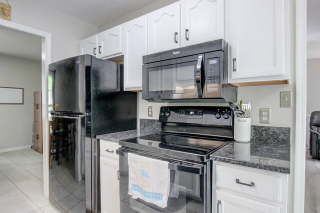 3473 Hunters Rdg, Woodlawn, TN 37191 - kitchen featuring dark stone countertops, light tile patterned floors, black appliances, and white cabinetry