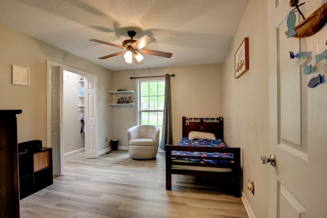3473 Hunters Rdg, Woodlawn, TN 37191 - bedroom with light wood-style floors, baseboards, ceiling fan, and a textured ceiling