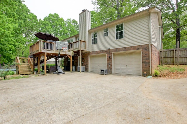 3473 Hunters Rdg, Woodlawn, TN 37191 - exterior space featuring fence, a deck, stairs, brick siding, and an attached garage