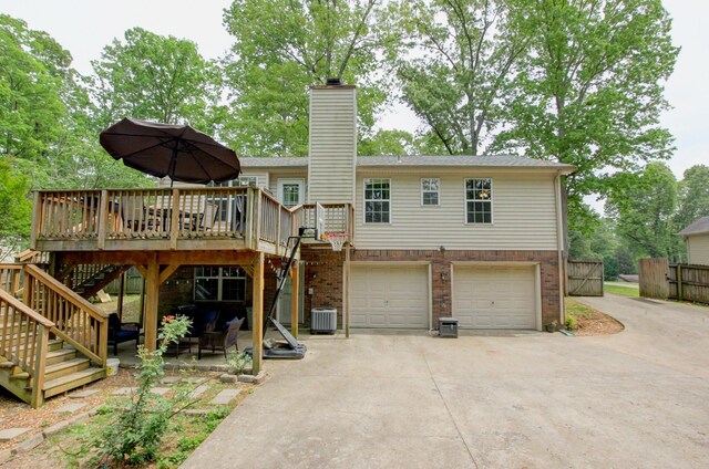 3473 Hunters Rdg, Woodlawn, TN 37191 - rear view of house featuring a chimney, central AC, driveway, and stairway