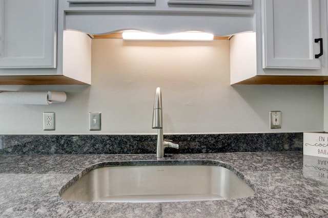 3473 Hunters Rdg, Woodlawn, TN 37191 - details with a sink and dark stone countertops