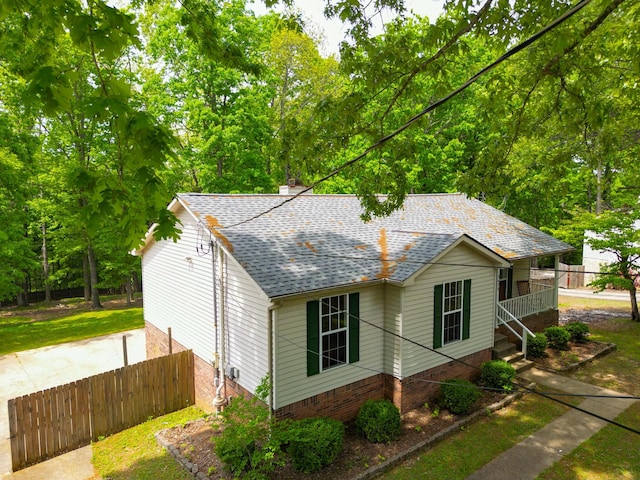 3473 Hunters Rdg, Woodlawn, TN 37191 - view of side of property featuring fence, a shingled roof, and a chimney