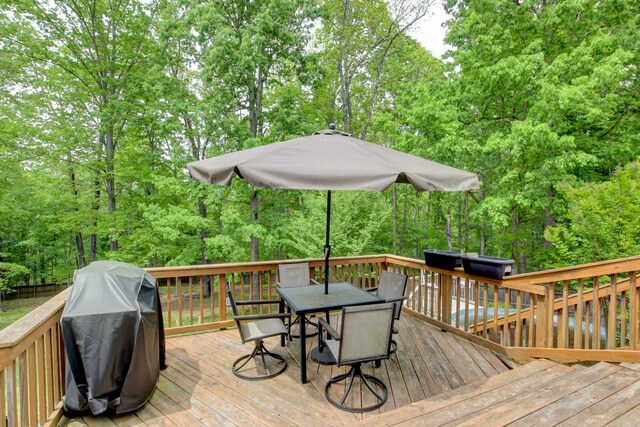 3473 Hunters Rdg, Woodlawn, TN 37191 - deck featuring outdoor dining space, grilling area, and a wooded view