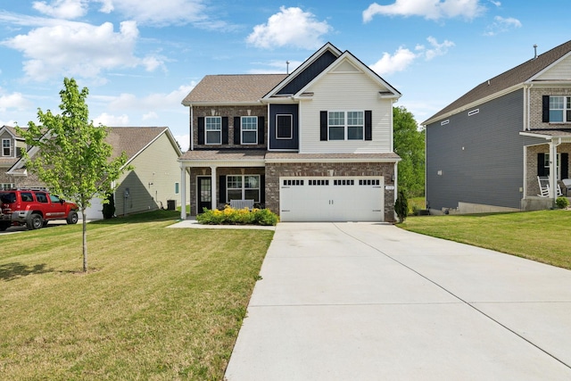 craftsman-style house featuring brick siding, an attached garage, a front yard, and driveway