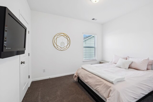 carpeted bedroom featuring visible vents and baseboards