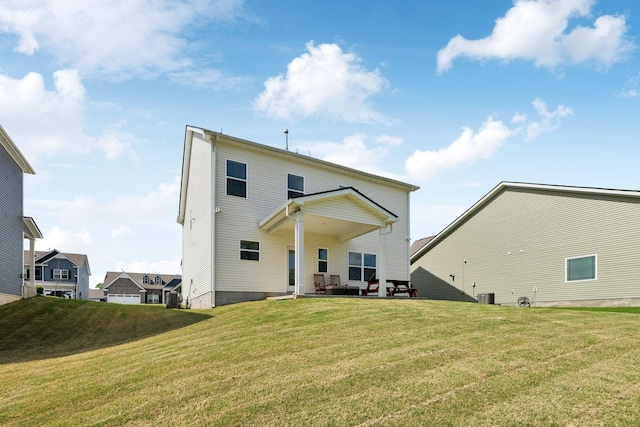 back of house featuring cooling unit, a patio area, and a lawn