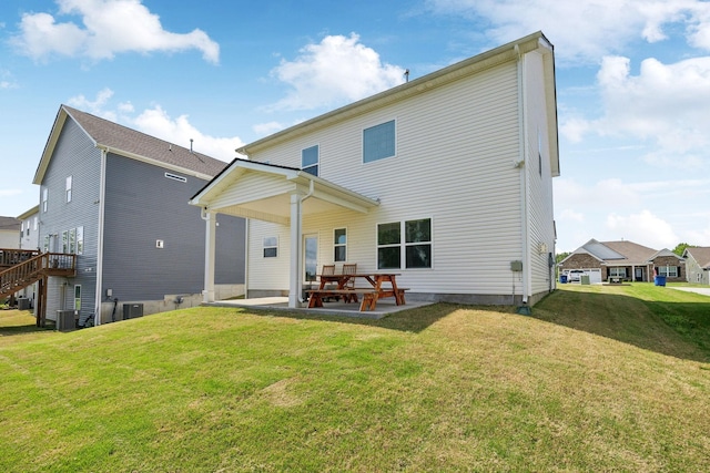 back of house with a lawn, central air condition unit, and a patio