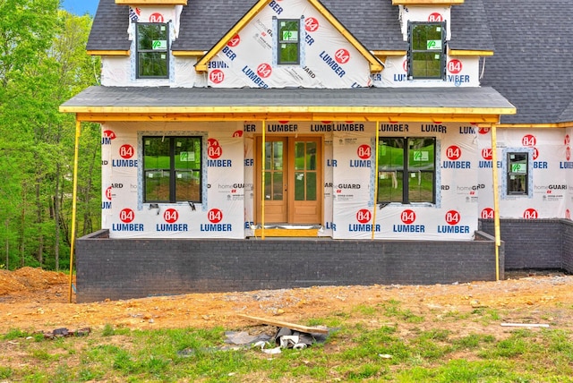 exterior space featuring a shingled roof