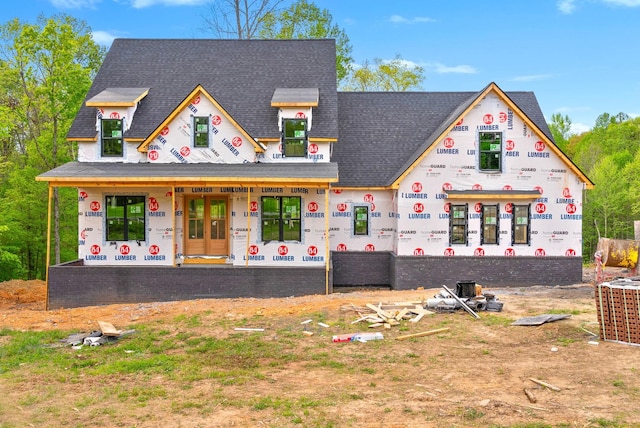 property under construction featuring a shingled roof