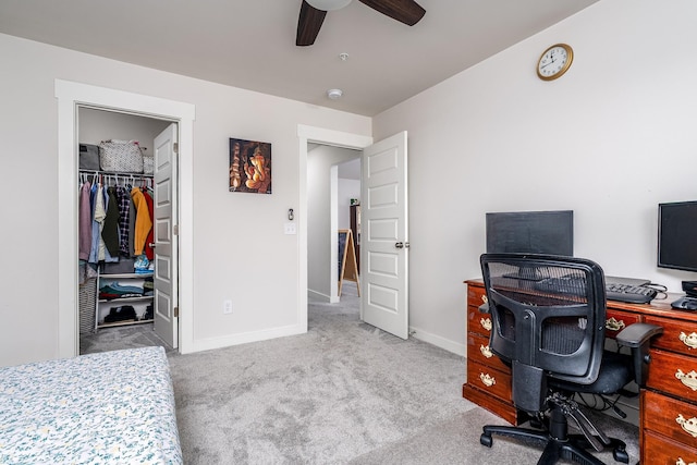 carpeted office featuring baseboards and ceiling fan