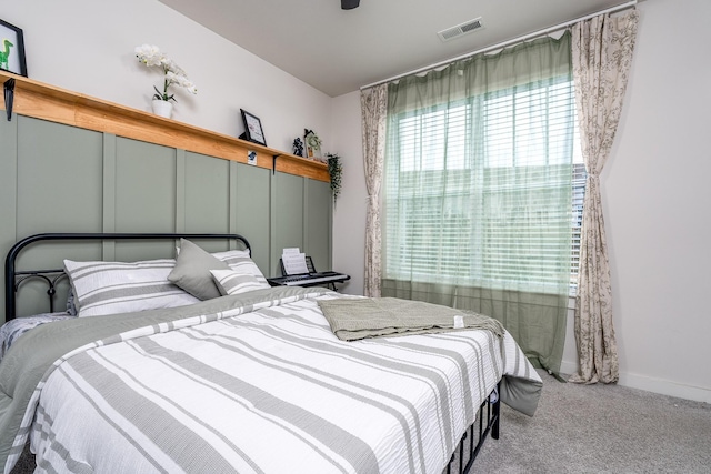 bedroom featuring baseboards, carpet flooring, and visible vents