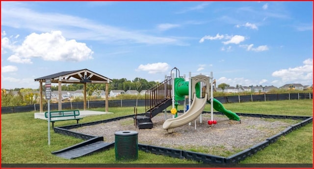 community jungle gym with fence and a yard