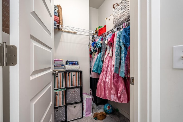 walk in closet featuring carpet flooring